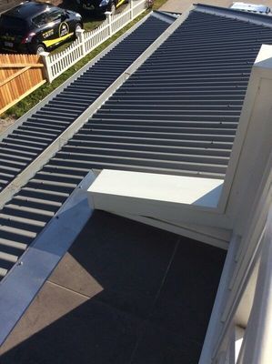 A Roof with A White Gutter — R&M Sheetmetal Nowra Metal Roofing in South Nowra, NSW
