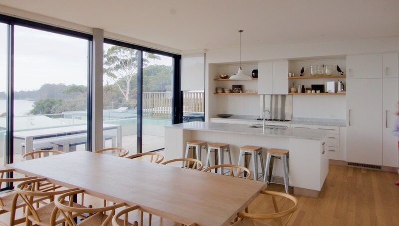 A Kitchen with A Large Table and Chairs and A Large Window — R&M Sheetmetal Nowra Metal Roofing in South Nowra, NSW