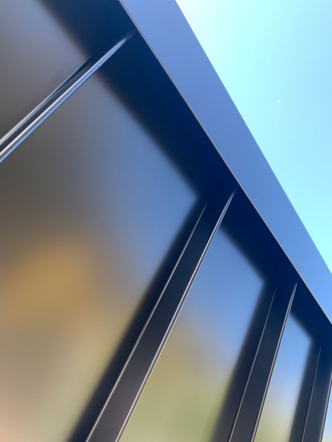 Looking up at a building with a blue sky in the background — R&M Sheetmetal Nowra Metal Roofing in Culburra, NSW