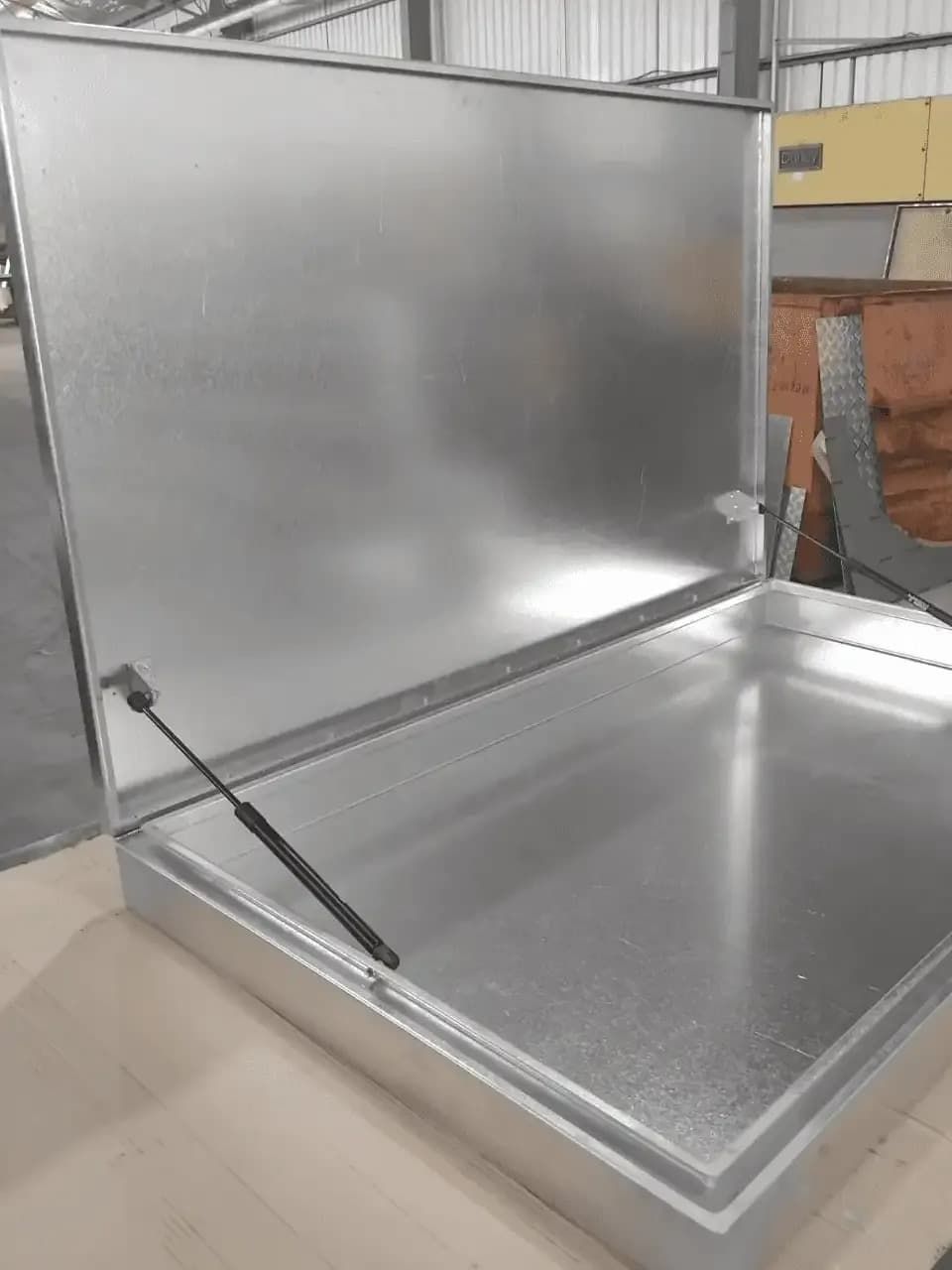 A Metal Box with The Lid Open Is Sitting on A Wooden Table — R&M Sheetmetal Nowra Metal Roofing in Culburra, NSW