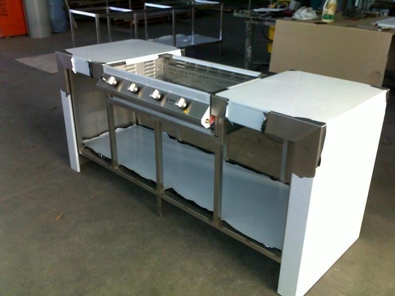 A Stainless Steel Grill Is Sitting on Top of A White Counter — R&M Sheetmetal Nowra Metal Roofing in Kiama, NSW