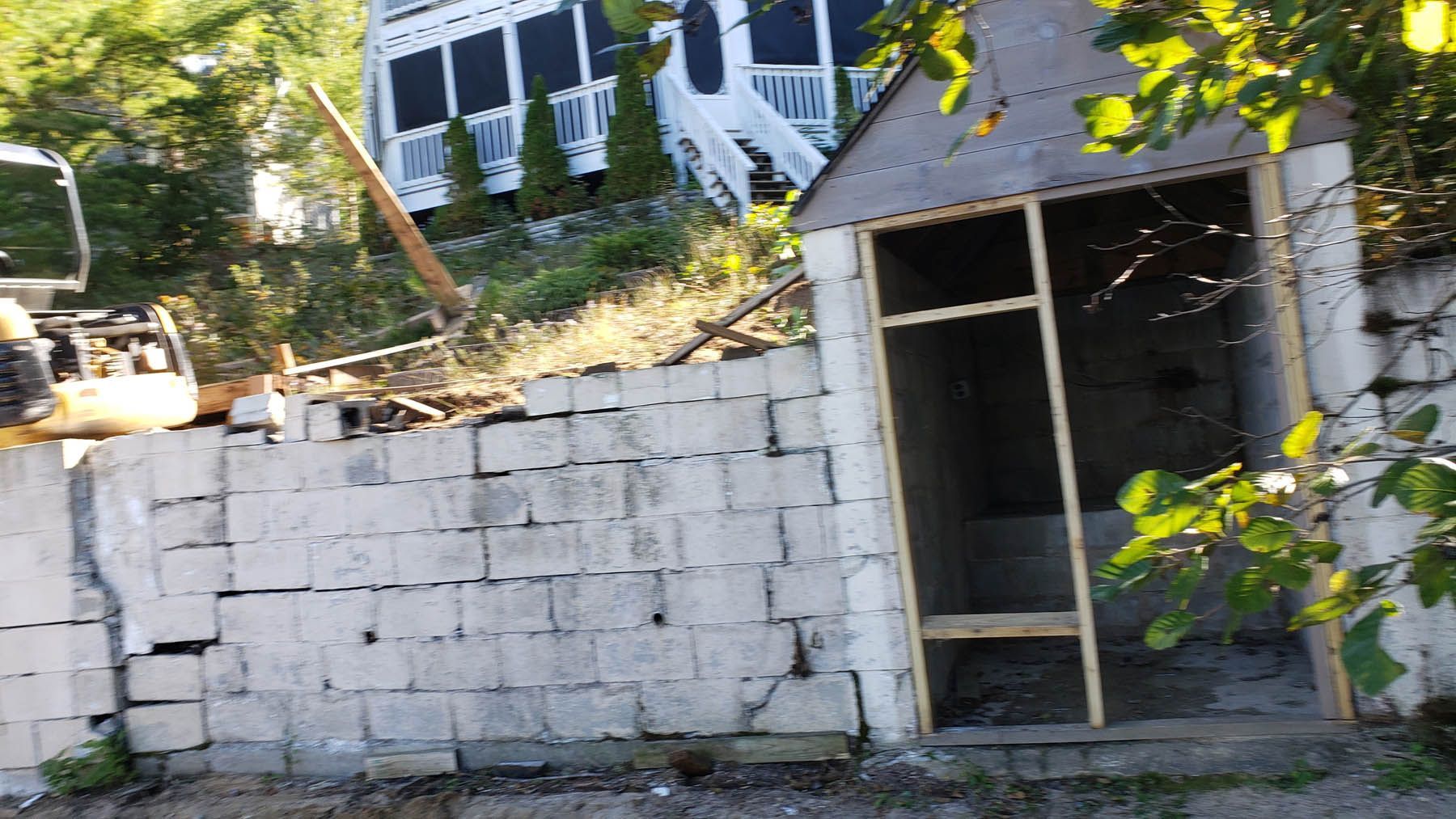 Concrete block retaining wall with a shed; a construction site.