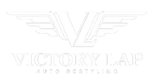 Logo for Victory Lap Auto Restyling: "V" shape with wings above text "VICTORY LAP AUTO RESTYLING".