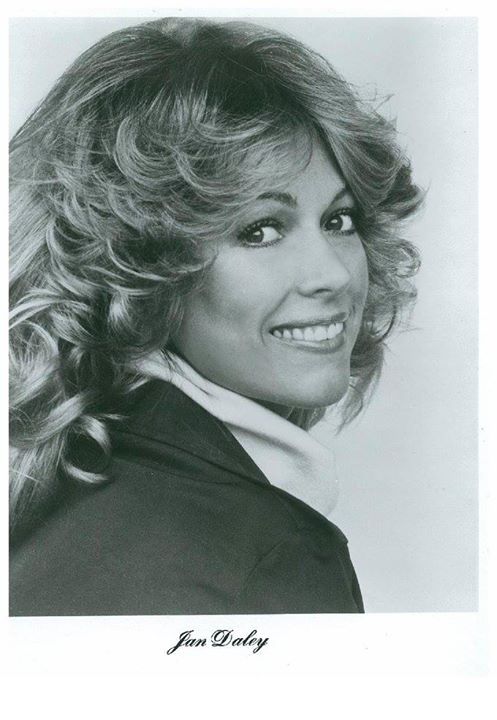 A black and white photo of a woman with long curly hair