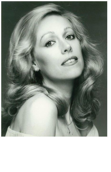 A black and white photo of a woman with long blonde hair.