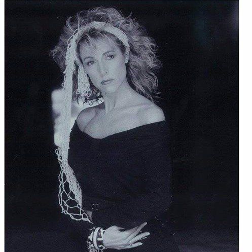 A black and white photo of a woman wearing a headband