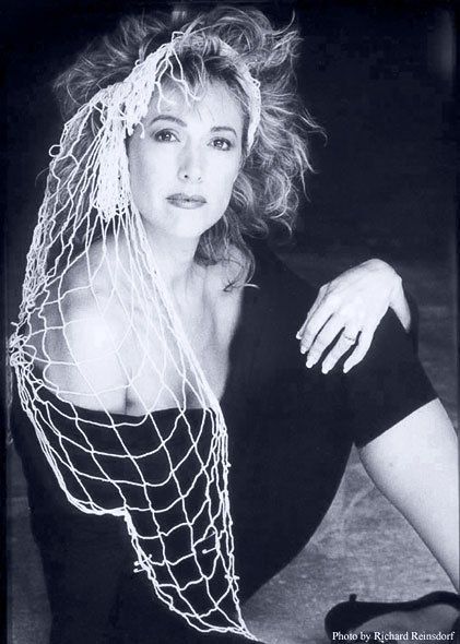 A black and white photo of a woman with a net around her head
