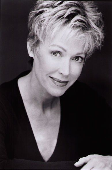 A black and white photo of a woman with short hair