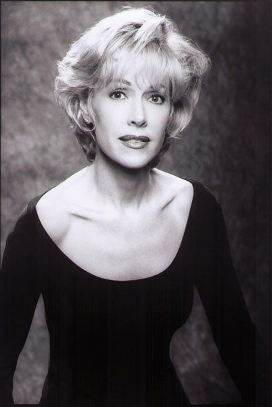 A black and white photo of a woman in a black dress