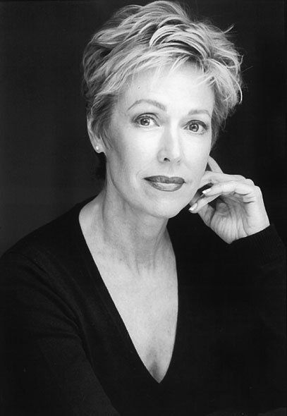 A black and white photo of a woman wearing a black sweater.