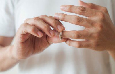 wedding ring being taken off finger