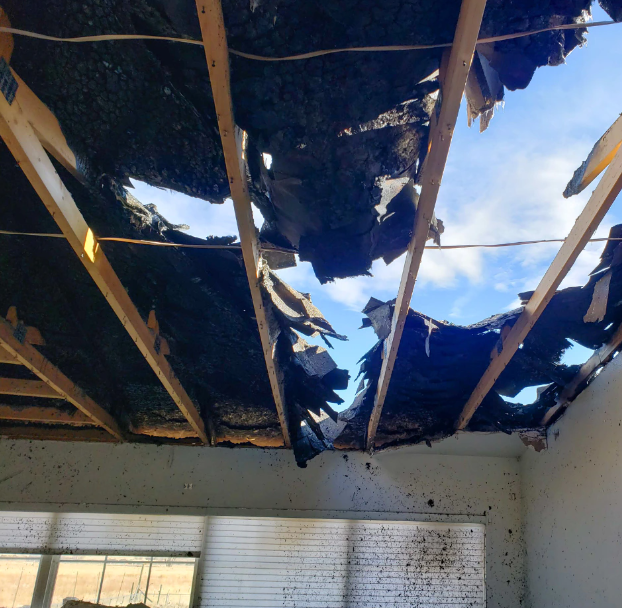 A room with a ceiling that has a hole in it