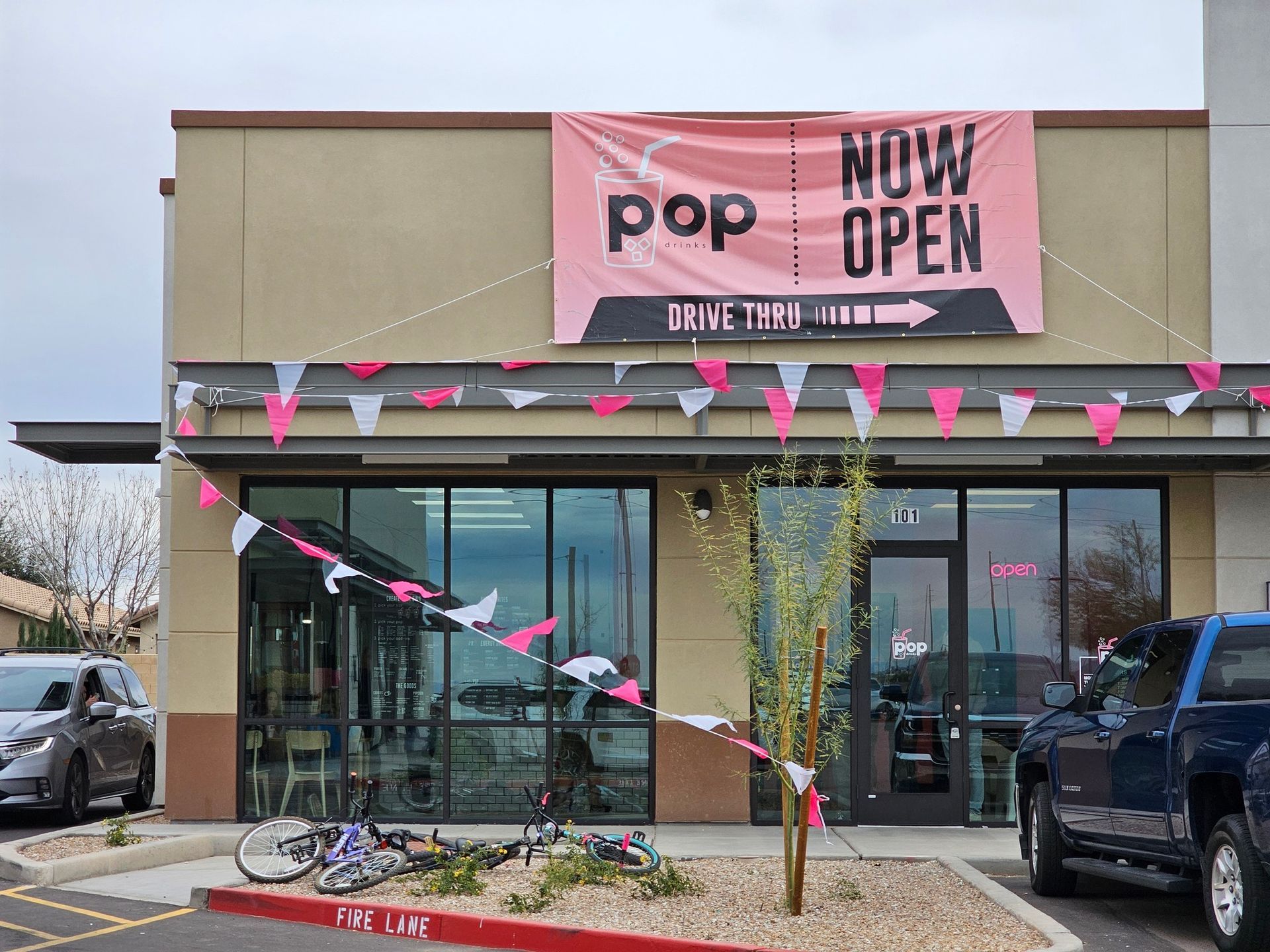 A store front with a sign that says now open