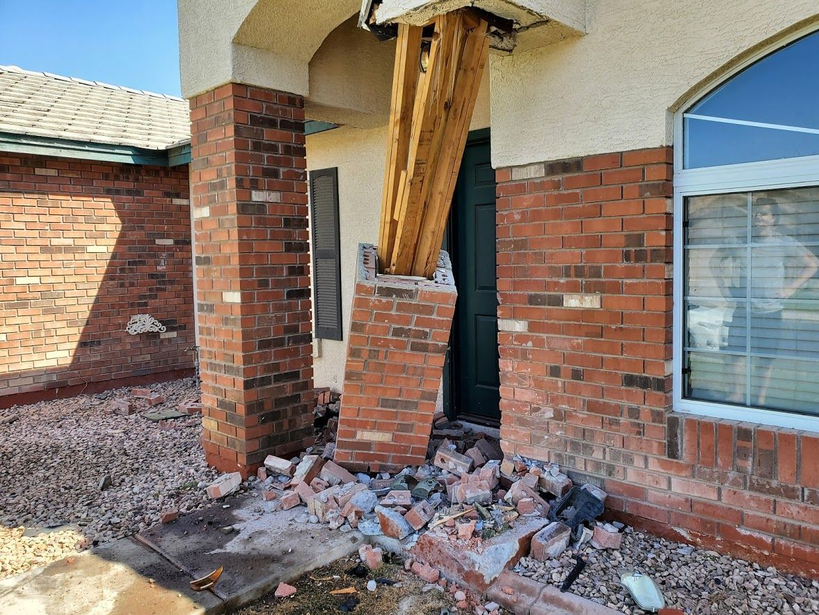 A brick building with a wooden post coming out of it.