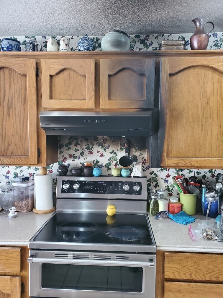 A kitchen with stainless steel appliances and wooden cabinets