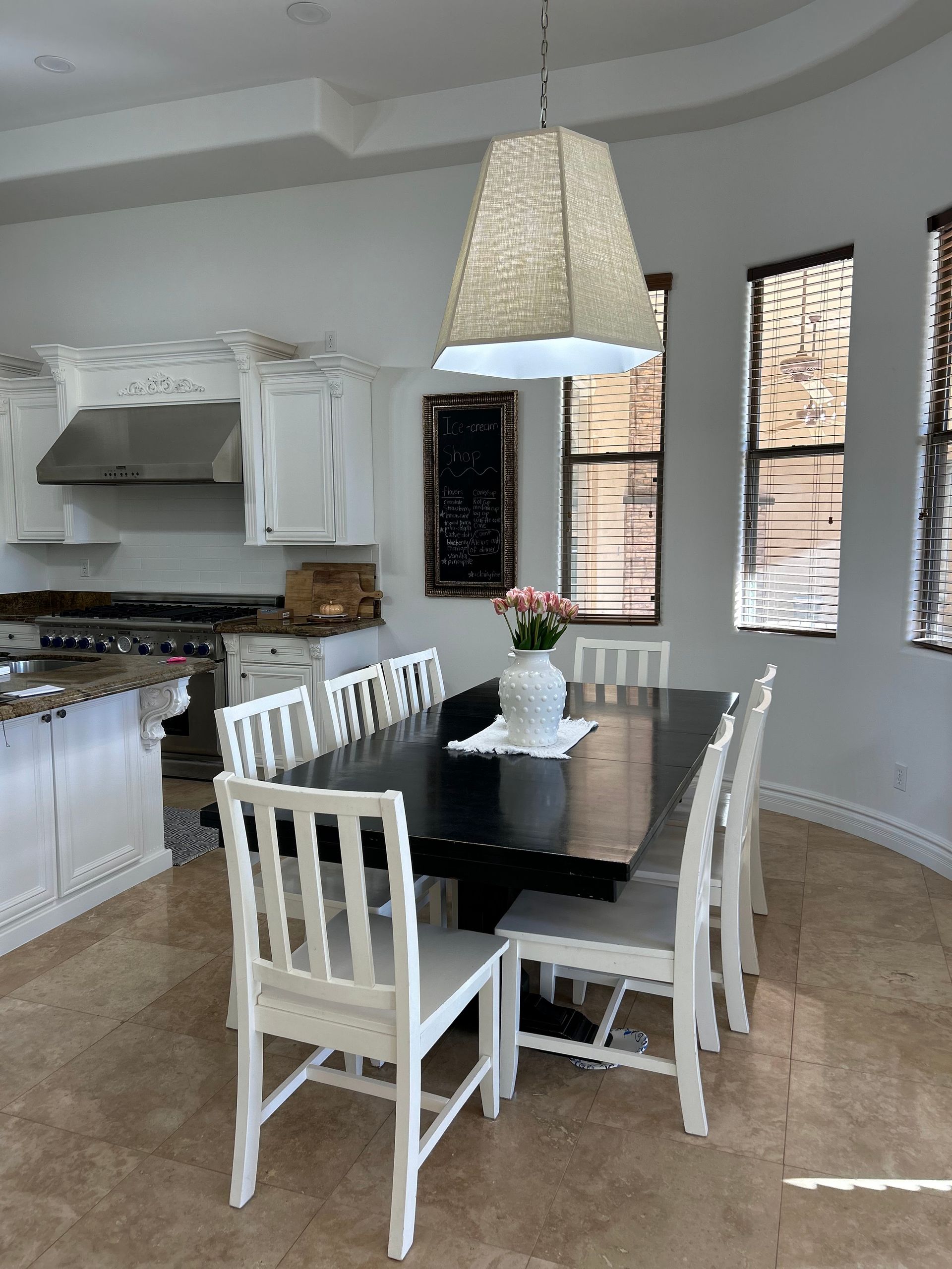 A dining room with a table and chairs in it