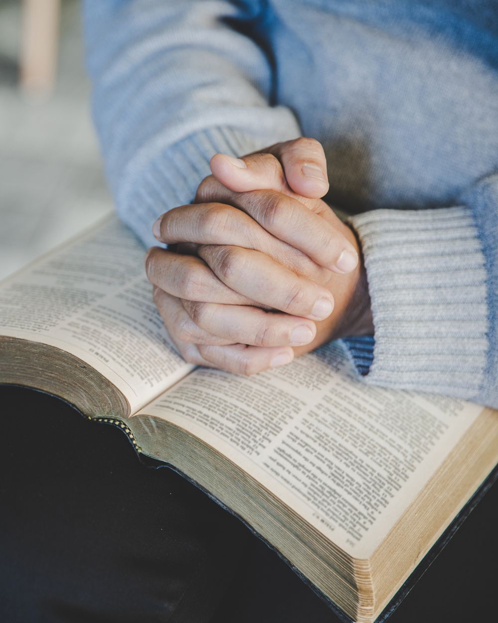 Woman Praying Over Her Bible