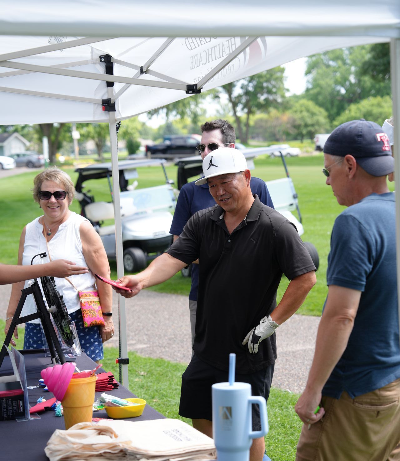 A golfer accepts a prize at Chip In For Children