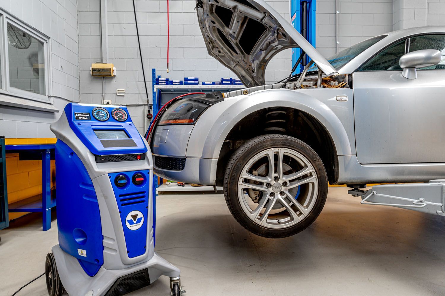 A Car Sitting On A Lift In A Garage - Prospect, SA - Topgear Automotive Services