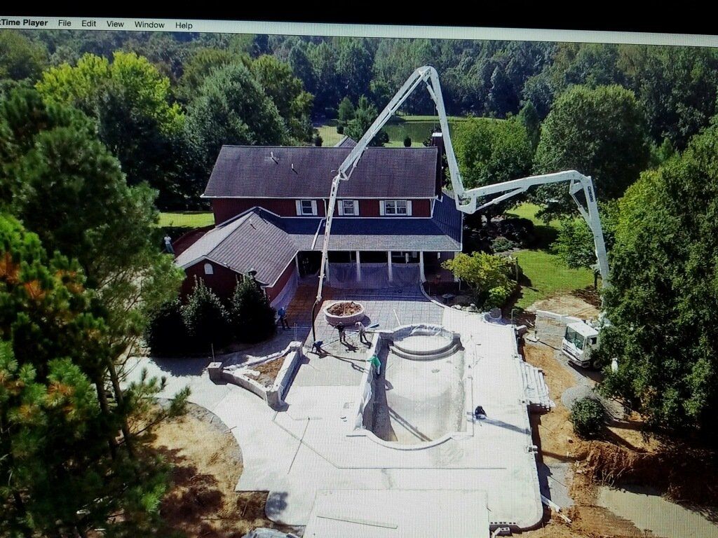 outdoor kitchen with two chairs and a stone fireplace