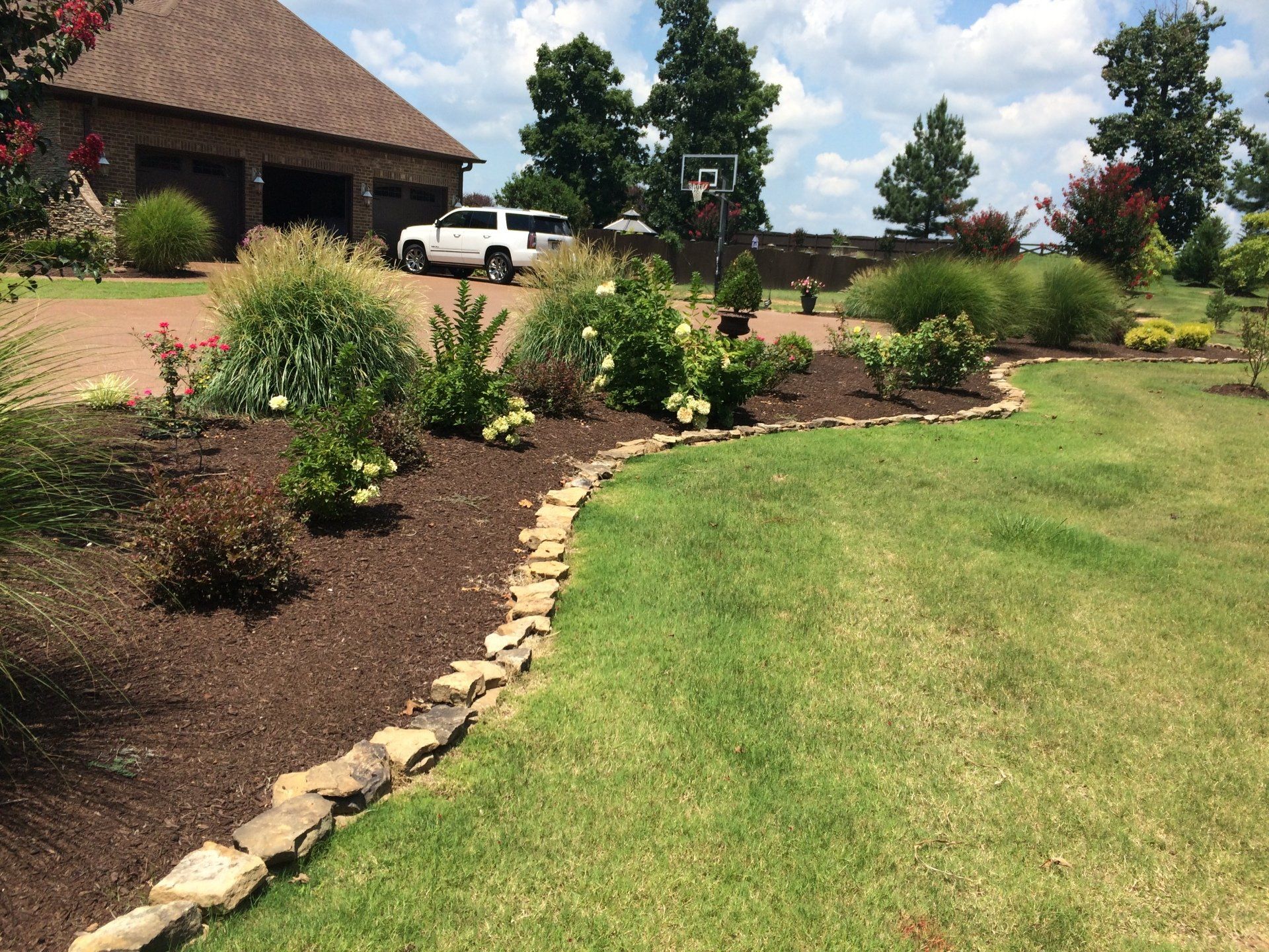 front yard landscaping with a variety of plants and flowers