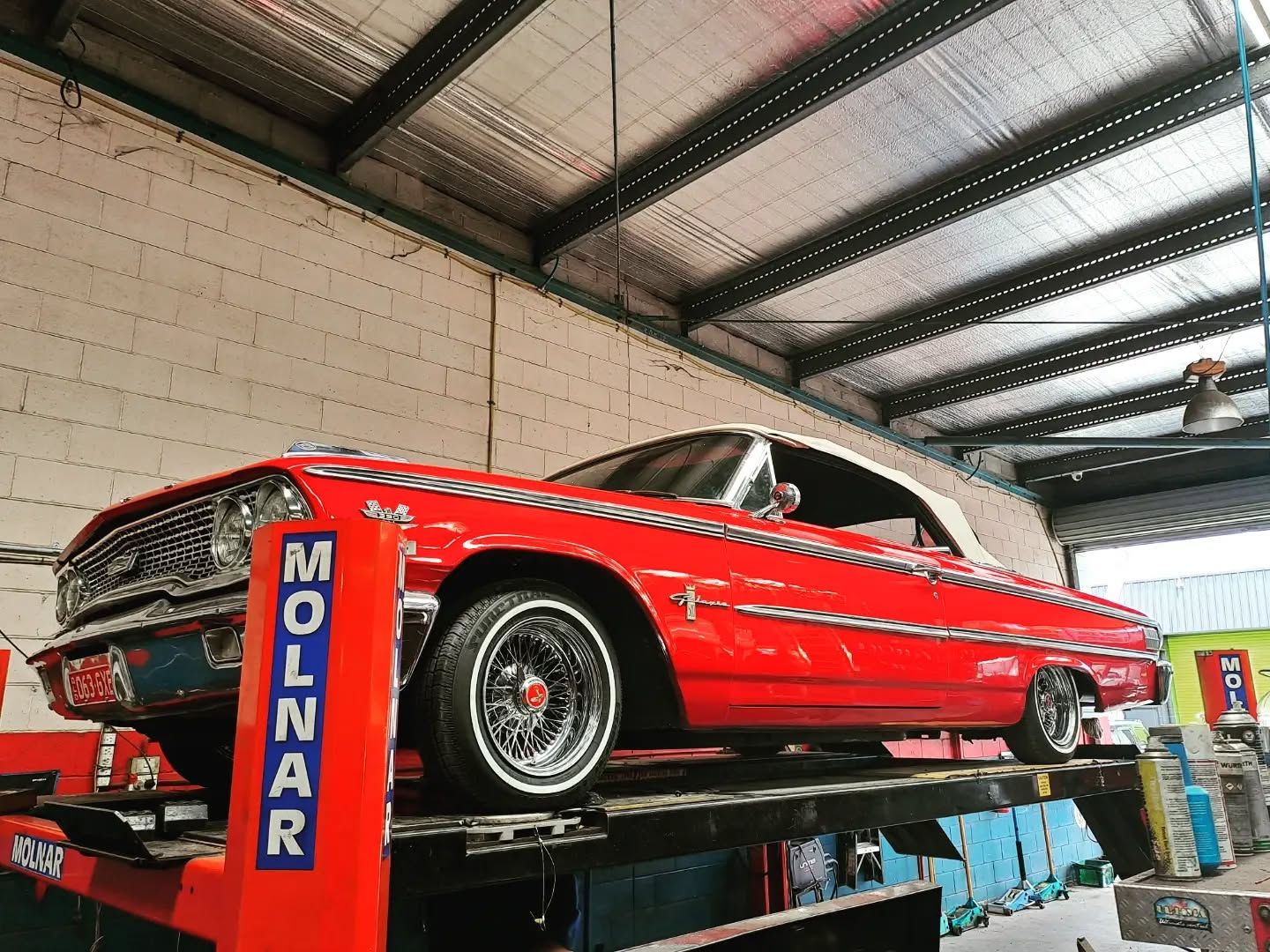 Red Classic Convertible Car on a Lift — BJM Mechanical Mufflers & Tyres in Oxenford, QLD