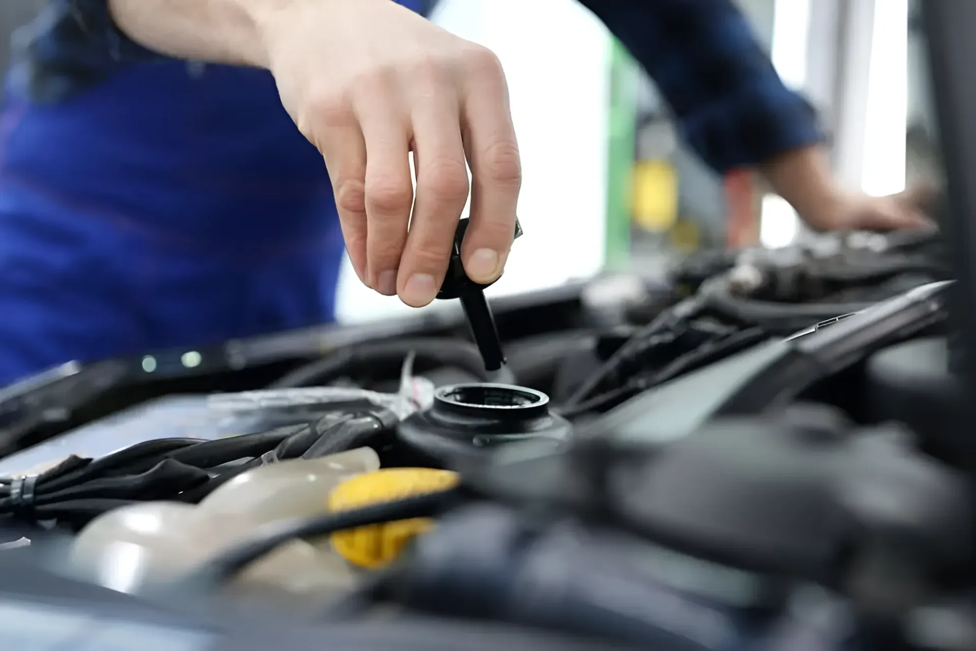 Person Checking Car Oil Level — BJM Mechanical Mufflers & Tyres in Oxenford, QLD