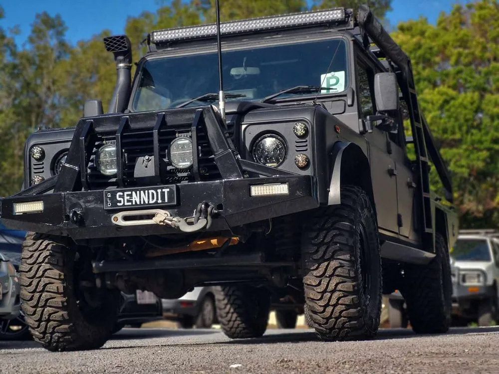 Black, Rugged Off-Road Vehicle With Large Tires And A Light Bar 