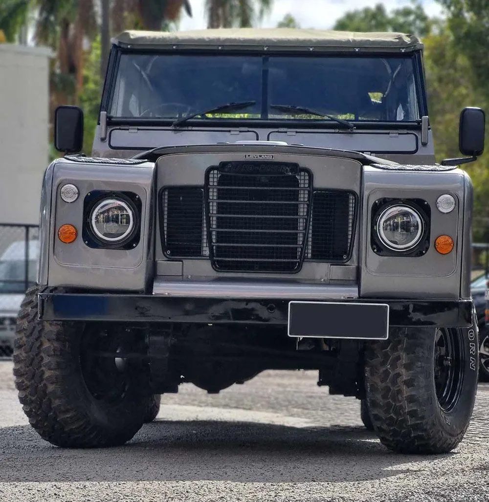 Gray Land Rover Defender Off-Road Vehicle With Large Tires 