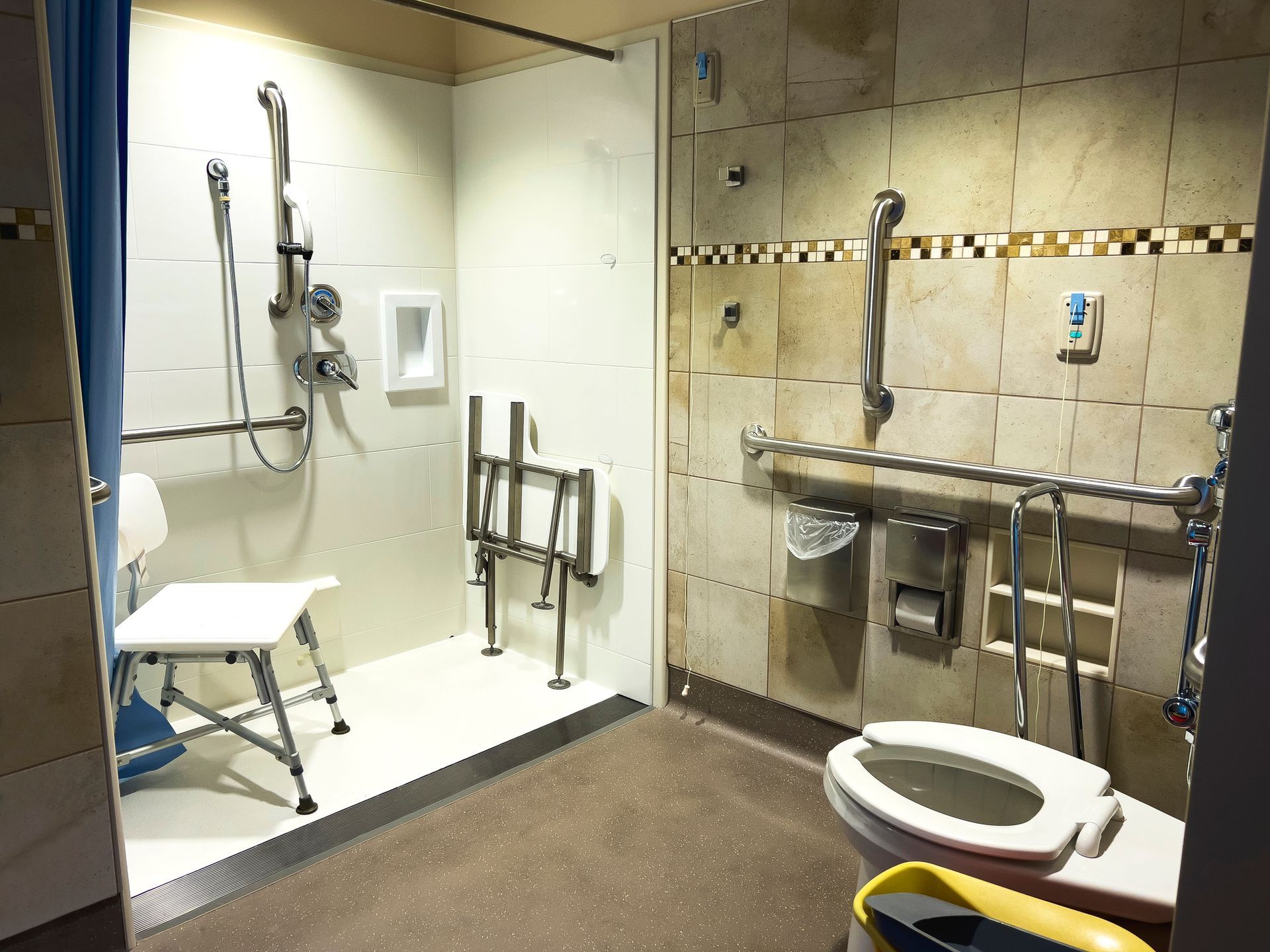 A man and a woman are sitting at a table looking at a tablet.