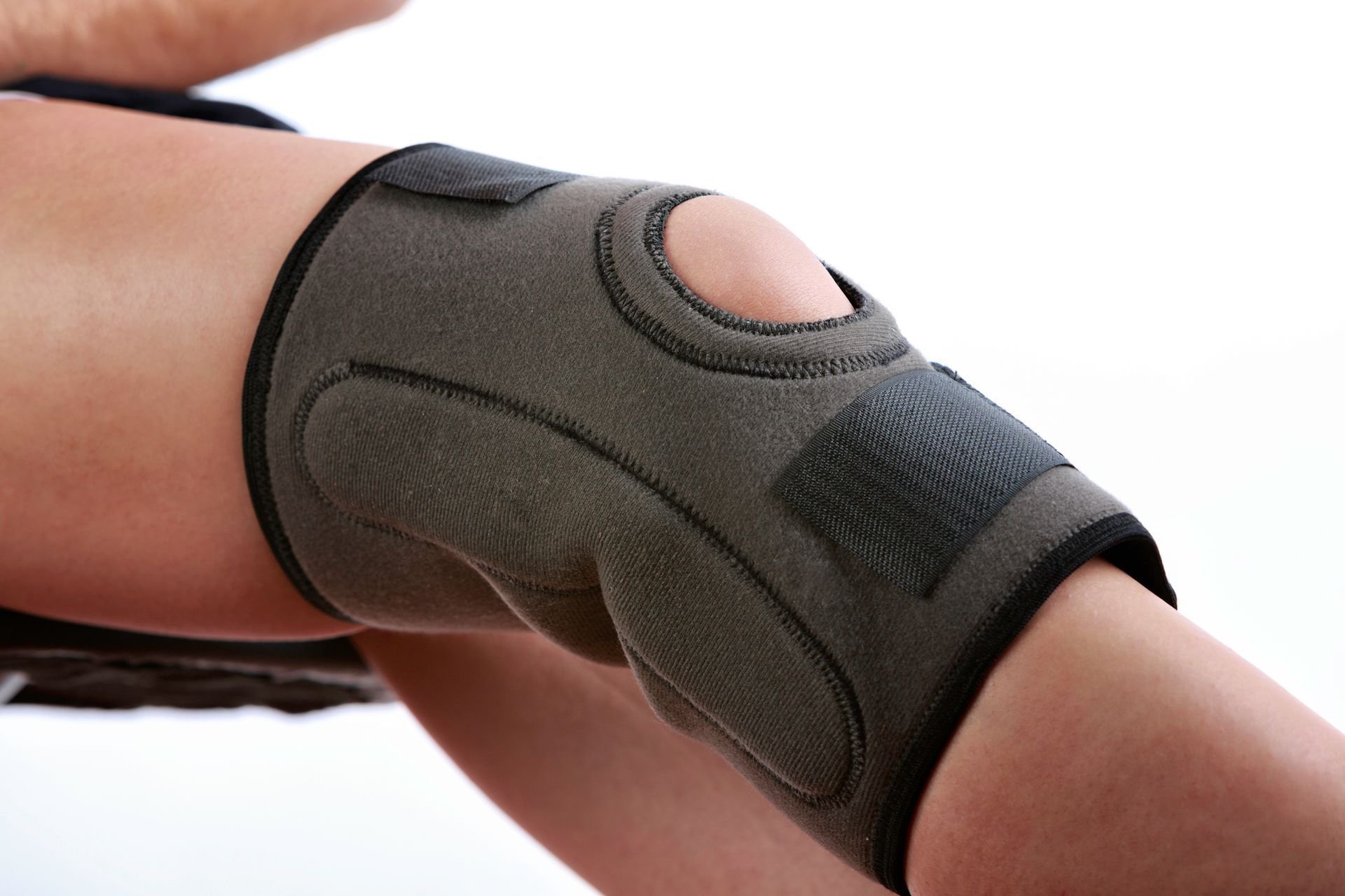 A person is wearing a knee brace on their leg