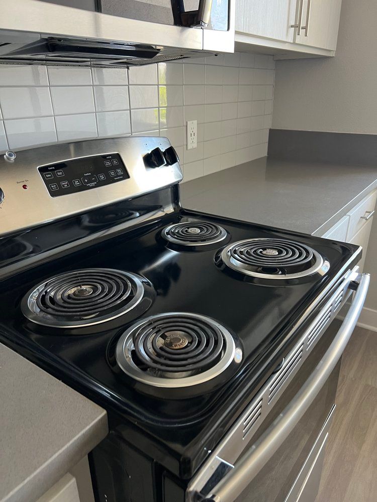 A black stove top oven is sitting on top of a kitchen counter.