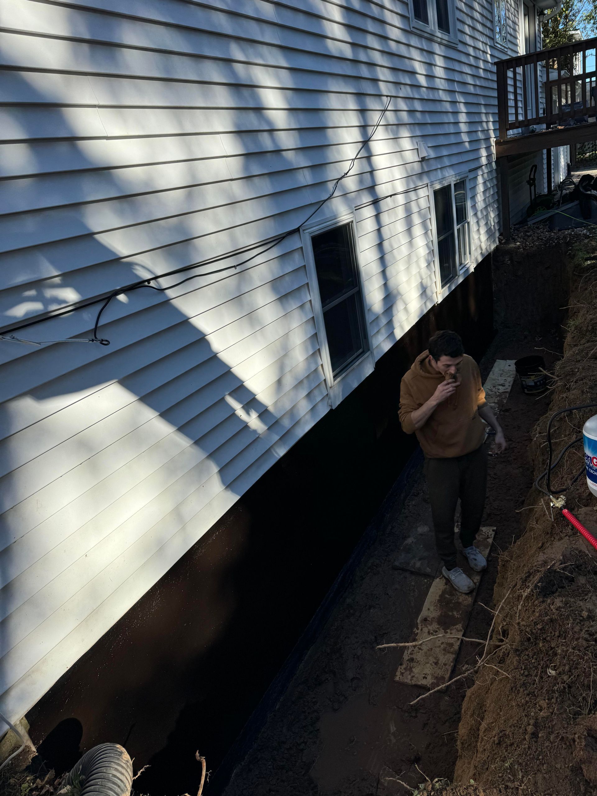 A white truck is parked in a parking lot next to a building.