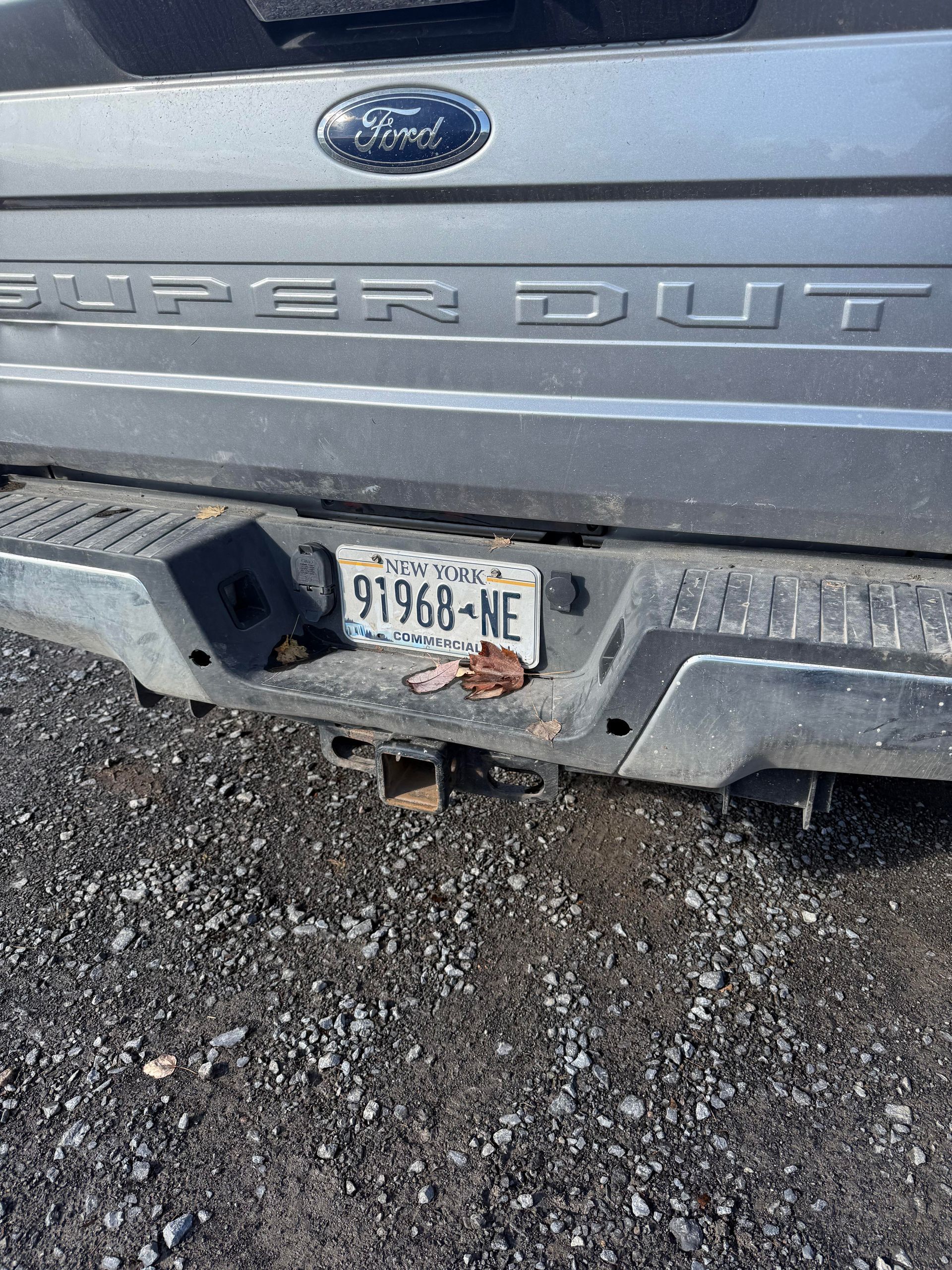 Rear bumper of a silver Ford truck with Nebraska license plate 91968-NE.