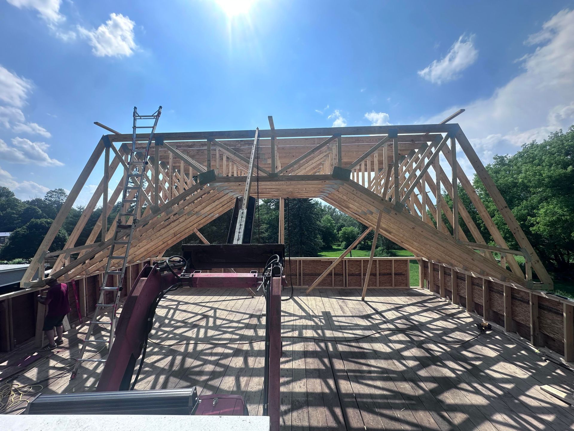 Construction of a wooden roof frame on a sunny day.