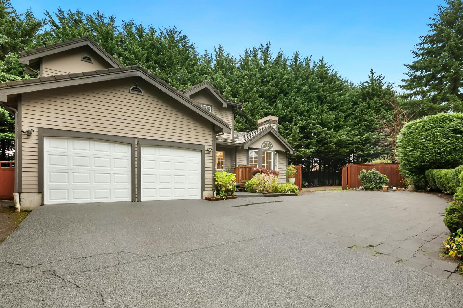 A house with two garage doors and a large driveway