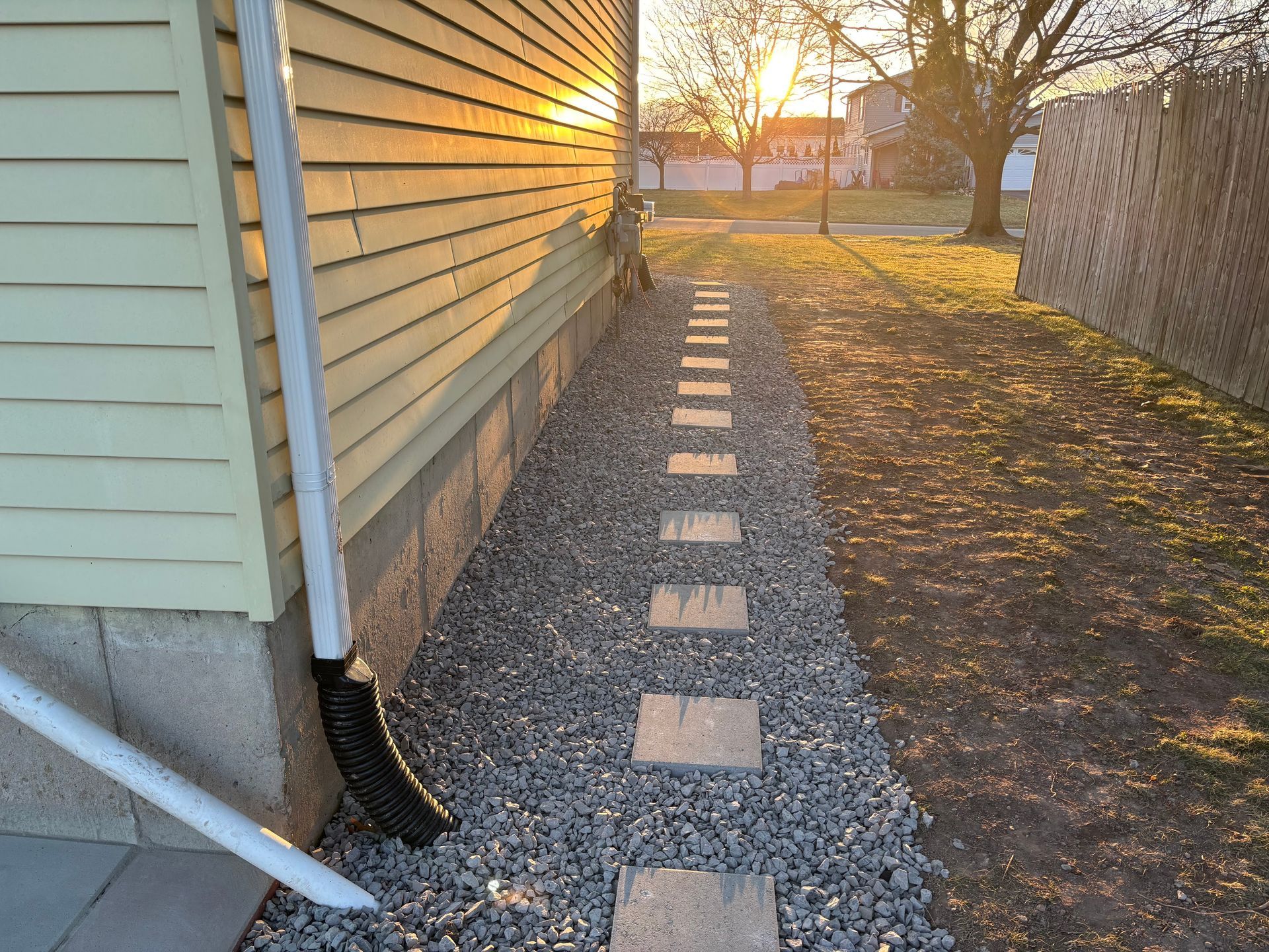 A walkway leading to the side of a house