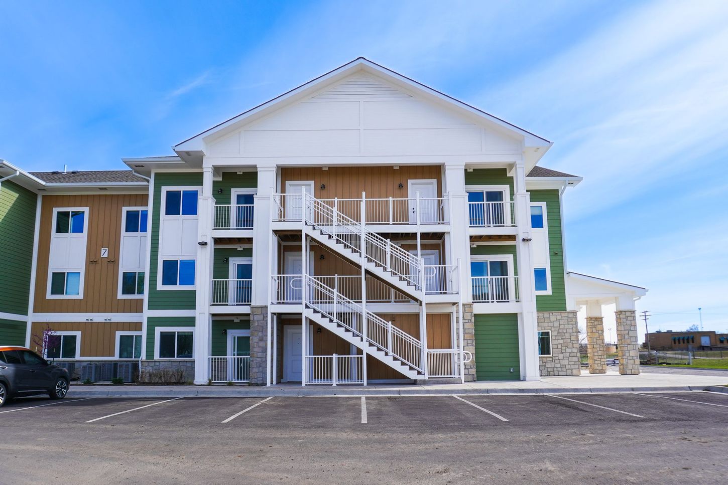 A large apartment building with stairs leading up to the second floor