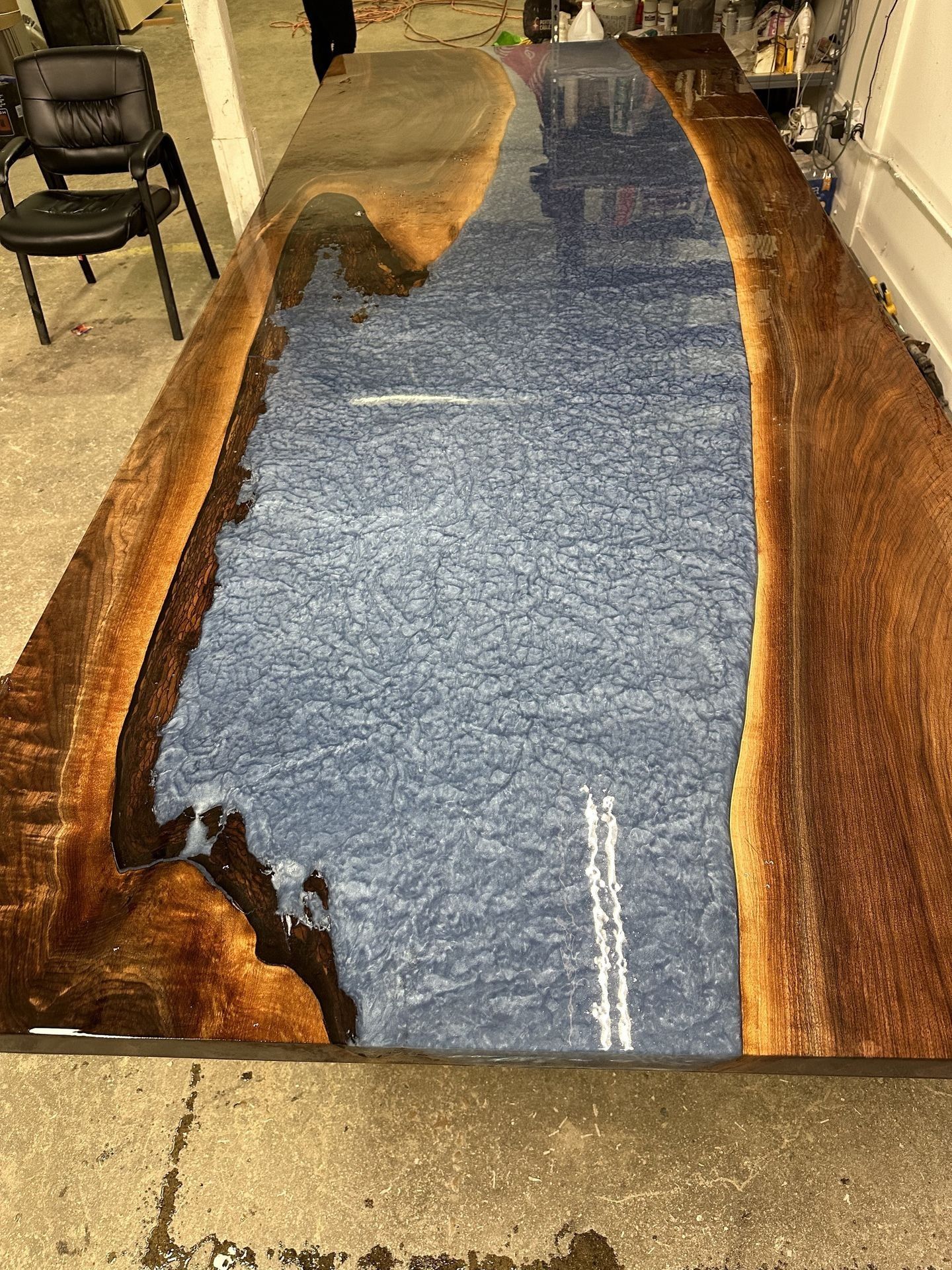A wooden table with a river in the middle of it.