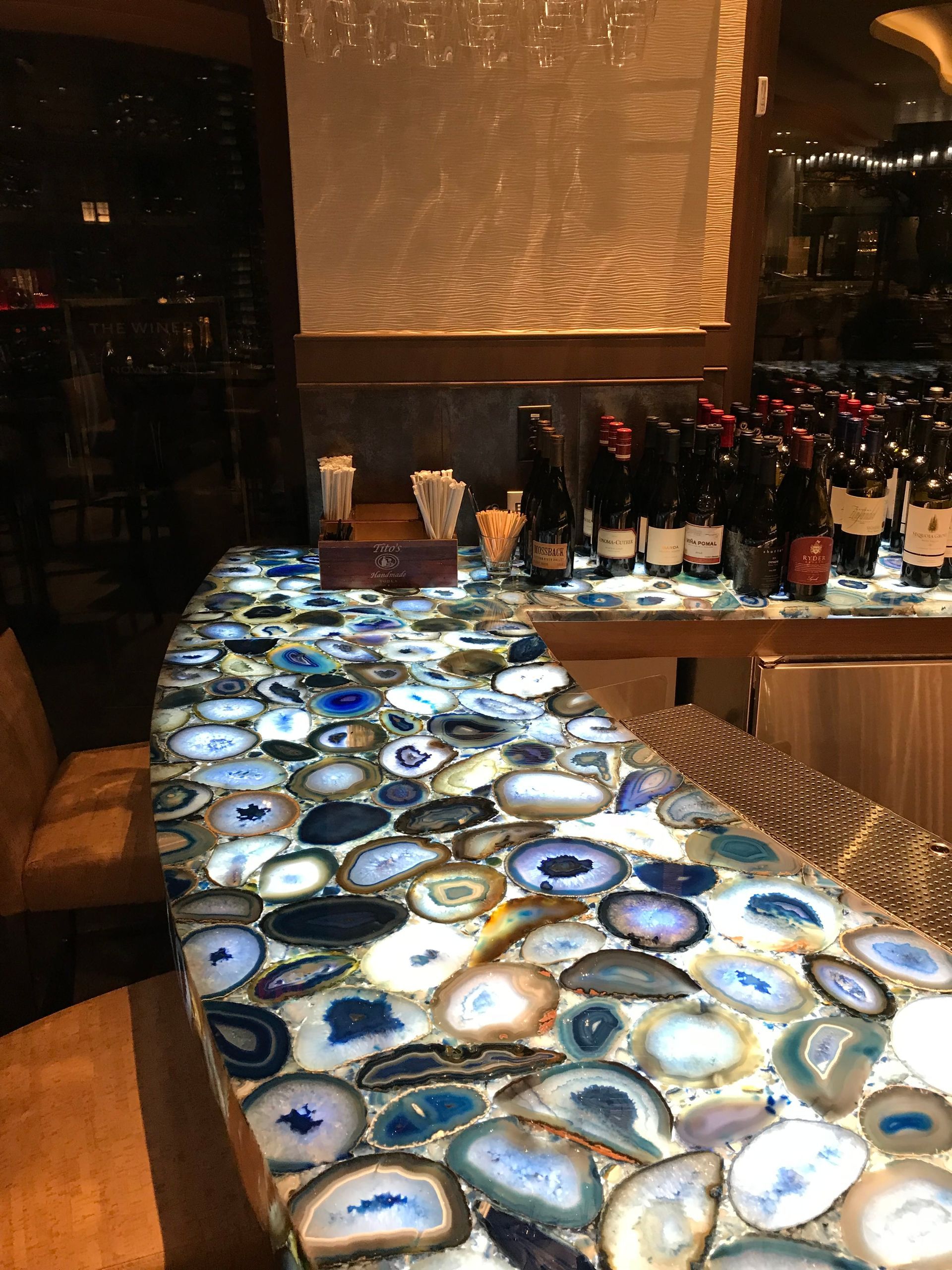 A bar with a lot of bottles of wine on it