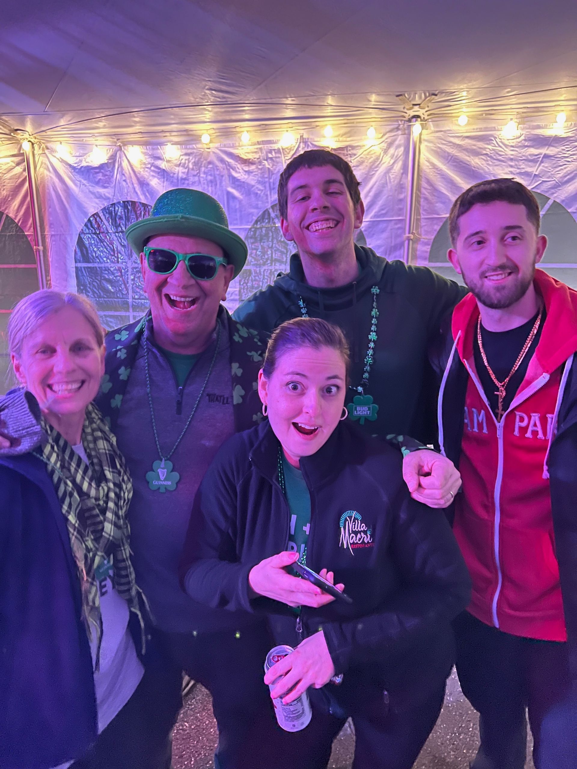 A group of people are posing for a picture in a tent.