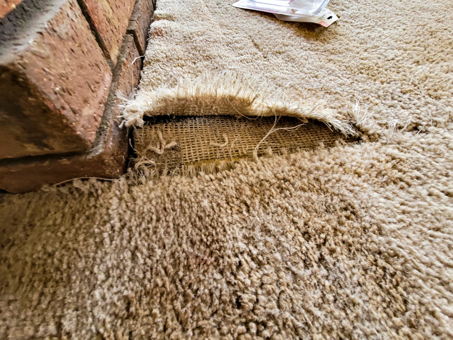 A close up of a carpet with a hole in it.