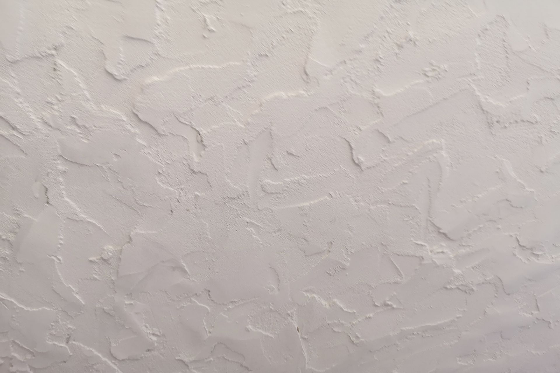 A close up of a white wall with a texture.