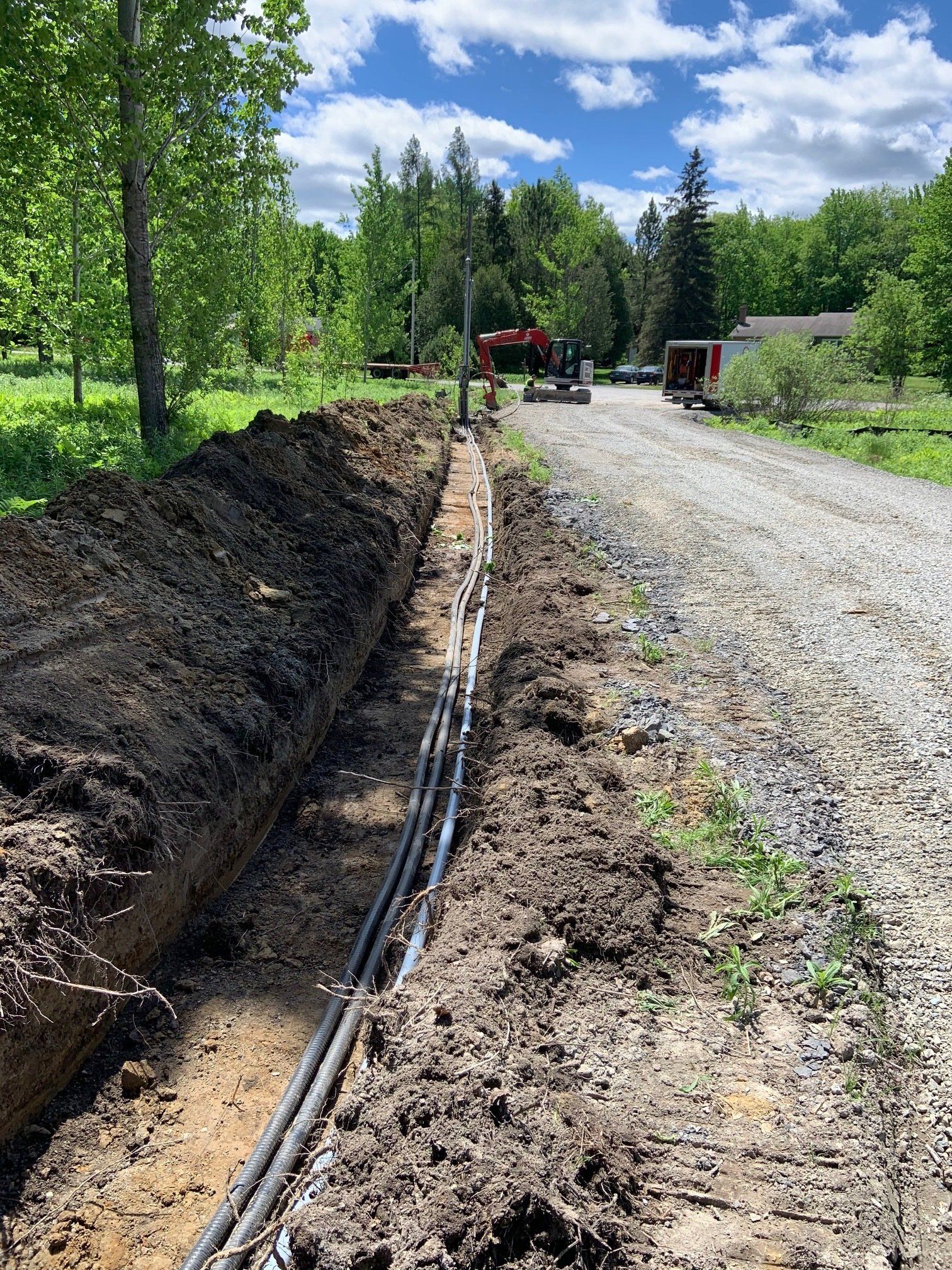 Un chemin de terre avec beaucoup de fils électriques dans la terre.