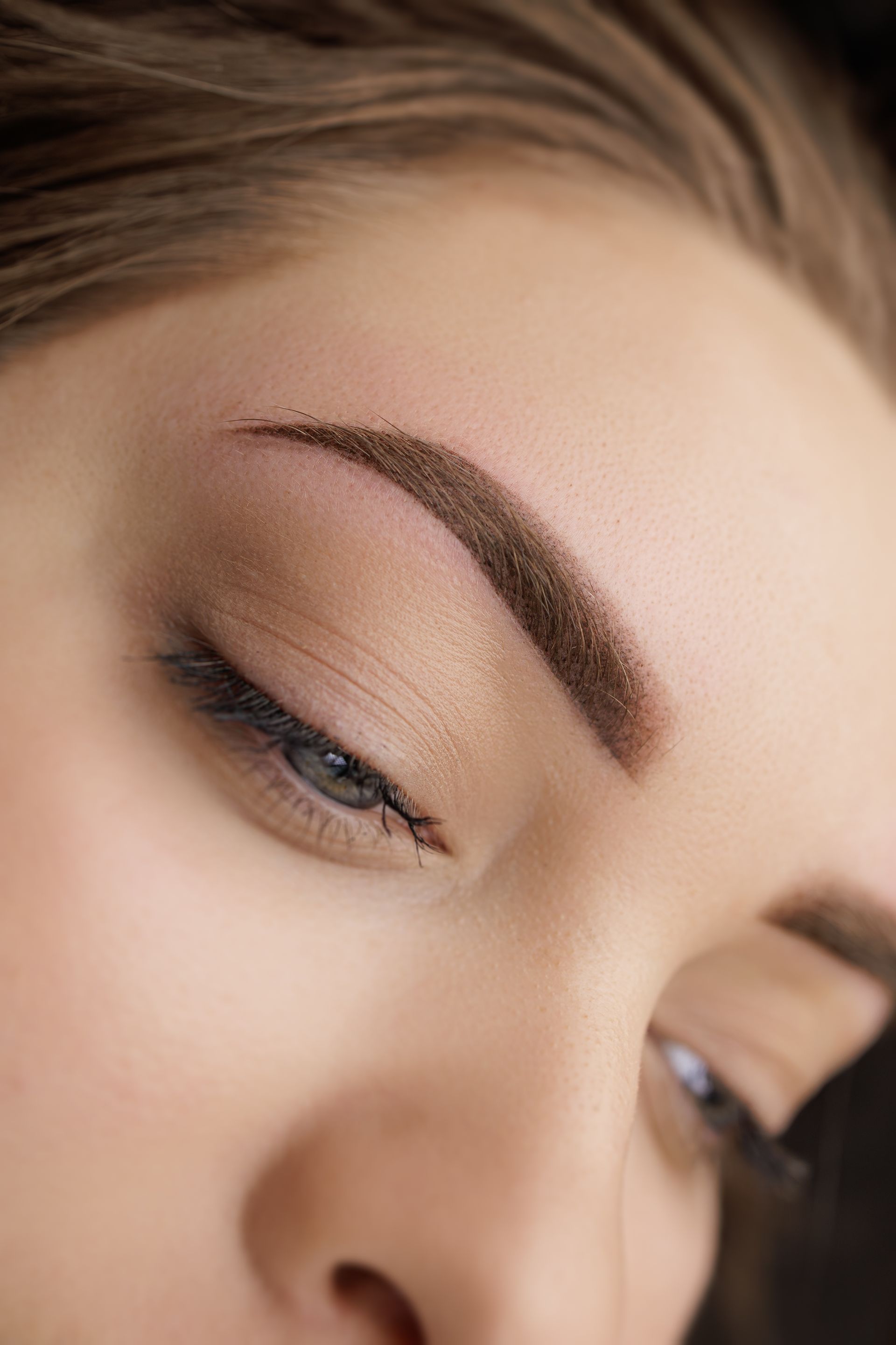 A close up of a woman 's face with her eyes closed.