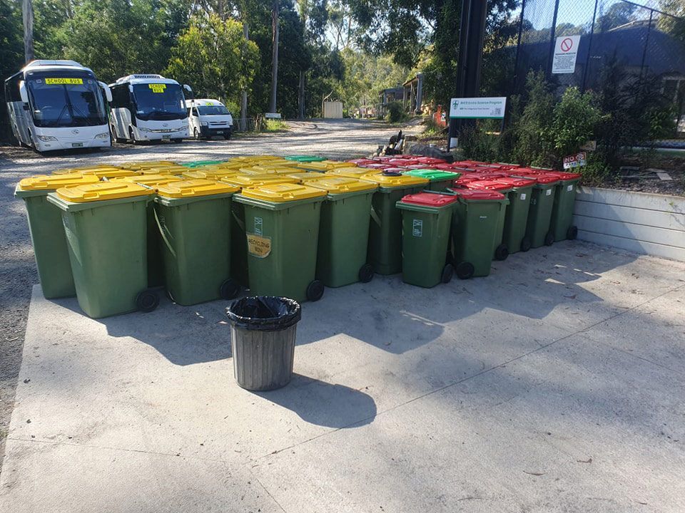 A Bunch Of Trash Cans Are Lined Up In A Parking Lot — Bin in a Bath in Saint Albans Park, VIC