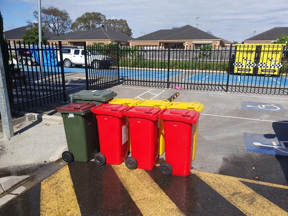 Three Trash Cans Are Lined Up In A Parking Lot — Bin in a Bath in Saint Albans Park, VIC