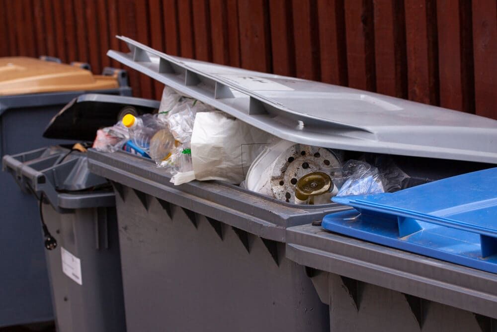 A Trash Can With the Lid Open is Filled With Trash — Bin in a Bath in Ballarat, VIC