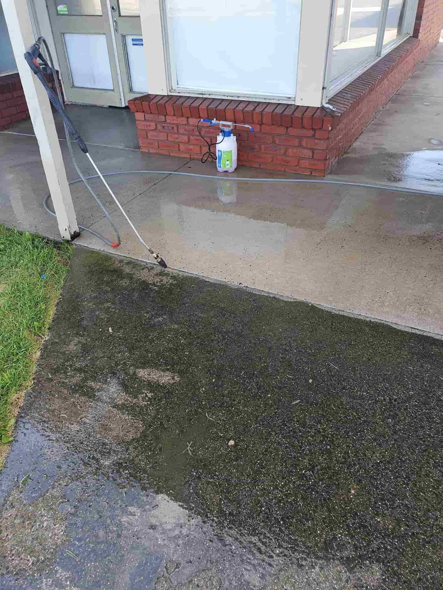 A Person is Cleaning a Sidewalk With a Pressure Washer — Bin in a Bath in Ballarat, VIC