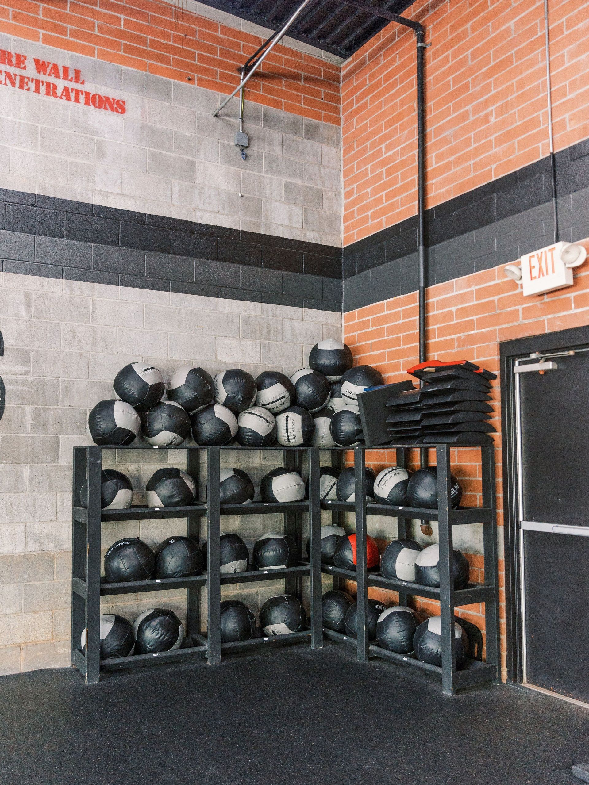 A room filled with lots of medicine balls on shelves.